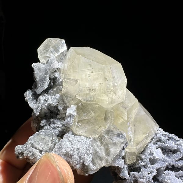 Glassy transparent calcite crystals on dark grey quartz from Fujian, China, top view
