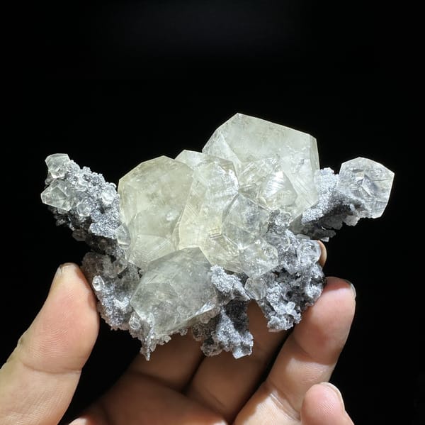 Glassy transparent calcite crystals on dark grey quartz from Fujian, China, detail of the matrix contact