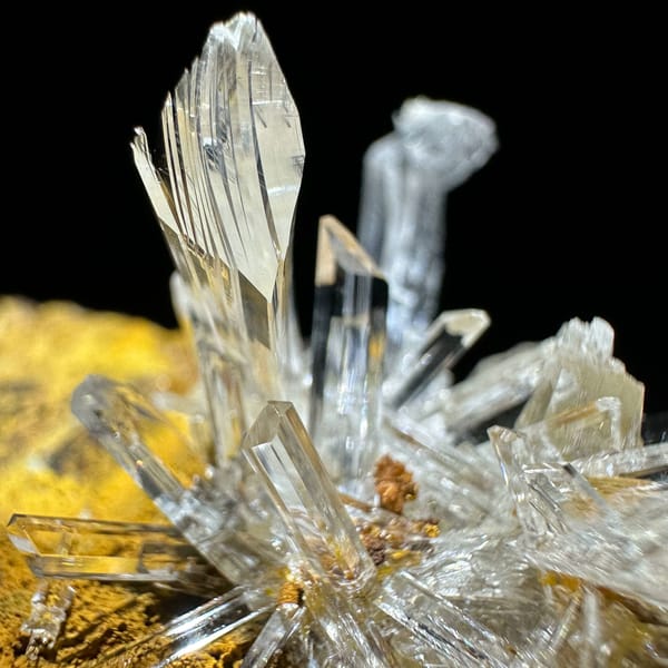Ultra-clear gypsum blades on ochre-yellow rock from Guizhou, China, second angle