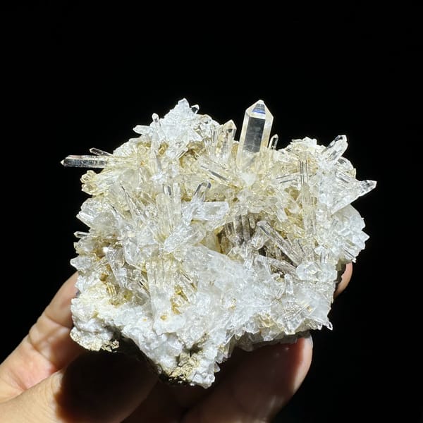 Dense cluster of transparent quartz needles from Hunan, China, close-up of the crystal faces