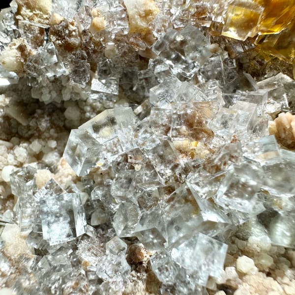 Ice-clear fluorite cubes on quartz plate from Guizhou, China, second angle