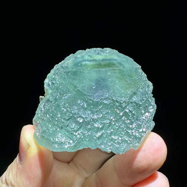 Large sea-green fluorite crystal with purple core from Guangxi, China, close-up of the crystal faces