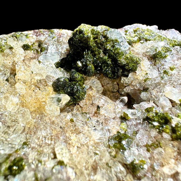 Sparkling quartz with green botryoidal epidote balls from Yunnan, China, close-up of the crystal faces