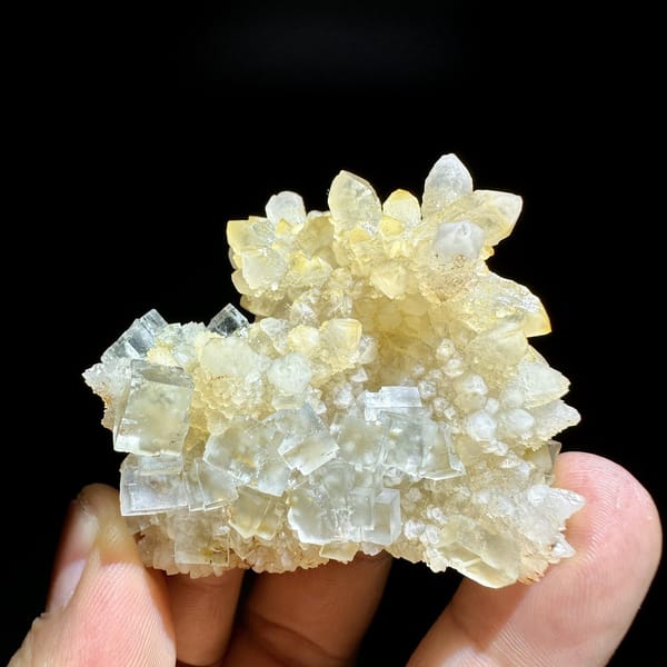 Ice-clear fluorite cubes on golden quartz cluster from Guizhou, China, detail of the matrix contact