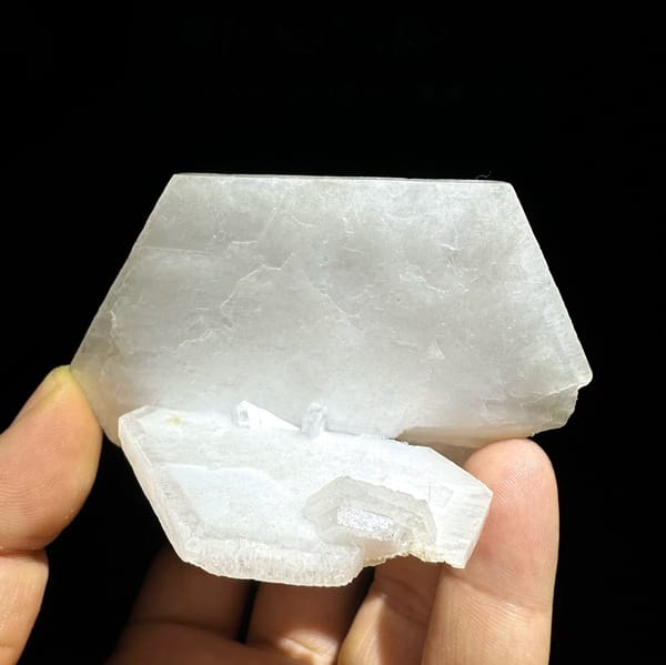 Large flat milky-white tabular calcite crystal from Fujian, China, held in hand