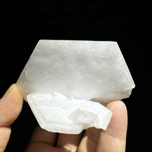 Large flat milky-white tabular calcite crystal from Fujian, China, detail of the matrix contact