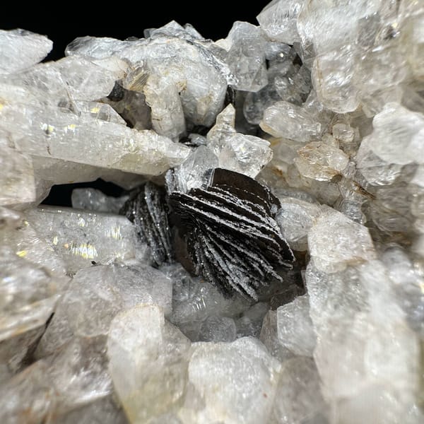 Tower of sugar-textured white quartz with black specular hematite from Guangdong, China, top view
