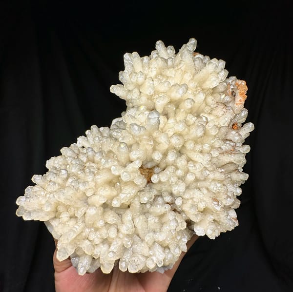 Plate of pale prismatic calcite crystals from Guizhou, China, close-up of the crystal faces