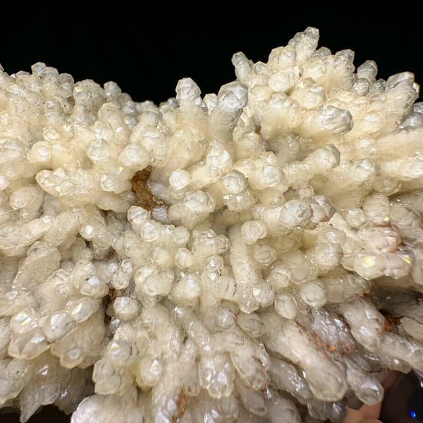 Plate of pale prismatic calcite crystals from Guizhou, China, reverse side