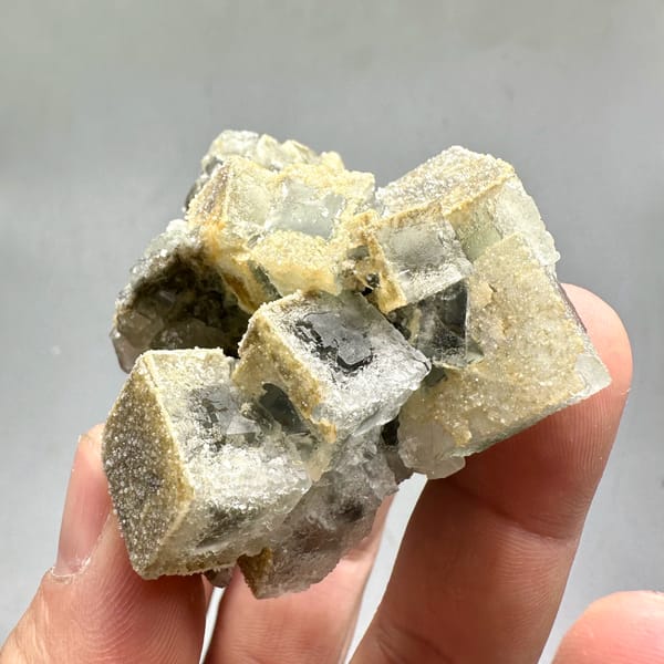 Etched cream fluorite cubes with sugary skin from Fujian, China, close-up of the crystal faces