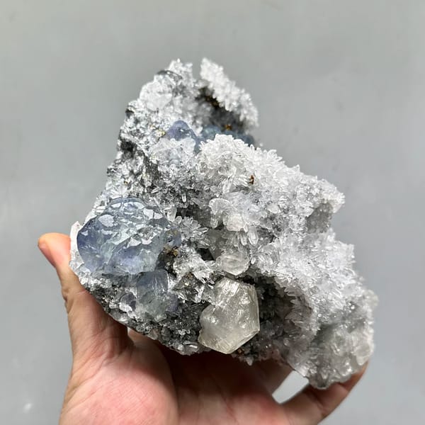 Large quartz druse plate with blue-green fluorite and calcite from Fujian, China, close-up of the crystal faces