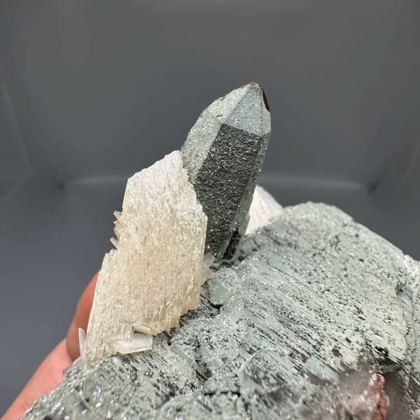 Clear quartz point on green chlorite block with calcite from Yunxiao, Fujian, China, top view
