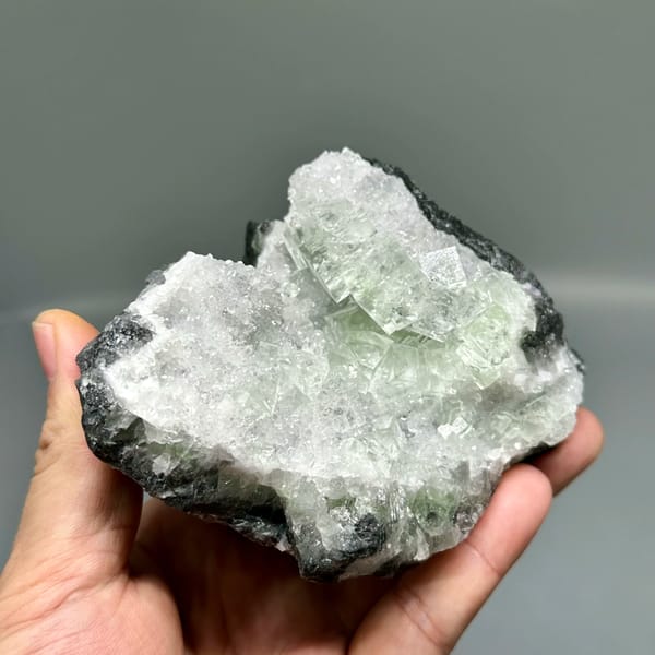 Glassy green fluorite under white quartz frosting from Zhejiang, China, second angle