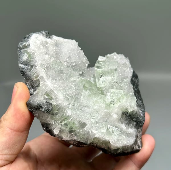 Glassy green fluorite under white quartz frosting from Zhejiang, China, reverse side