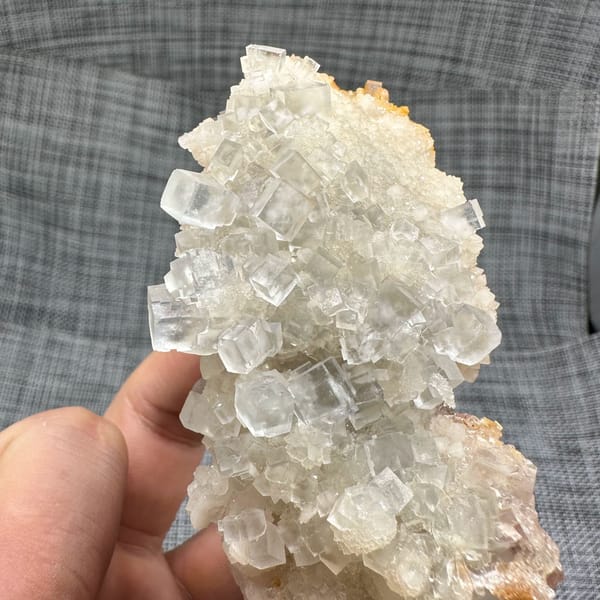 Colourless fluorite cubes on quartz plate from Guizhou, China, close-up of the crystal faces