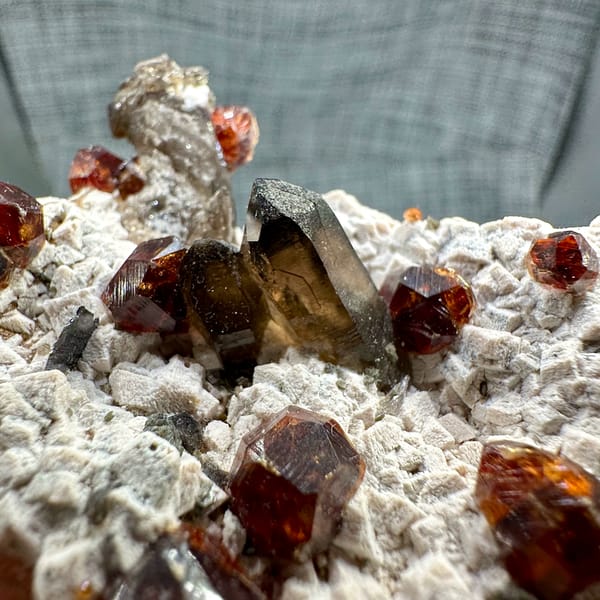 Large orange-red garnets and smoky quartz on cream feldspar from Yunxiao, Fujian, China, second angle