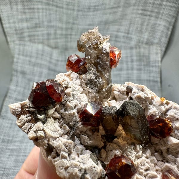 Large orange-red garnets and smoky quartz on cream feldspar from Yunxiao, Fujian, China, reverse side