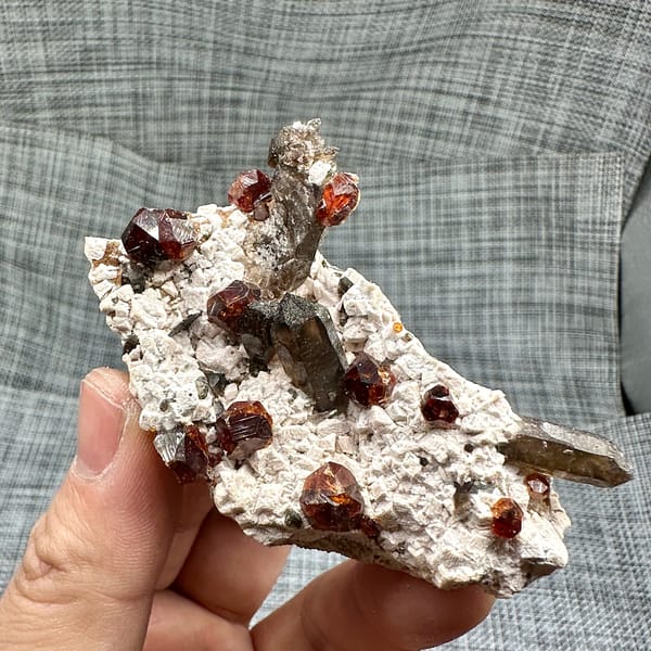 Large orange-red garnets and smoky quartz on cream feldspar from Yunxiao, Fujian, China, top view