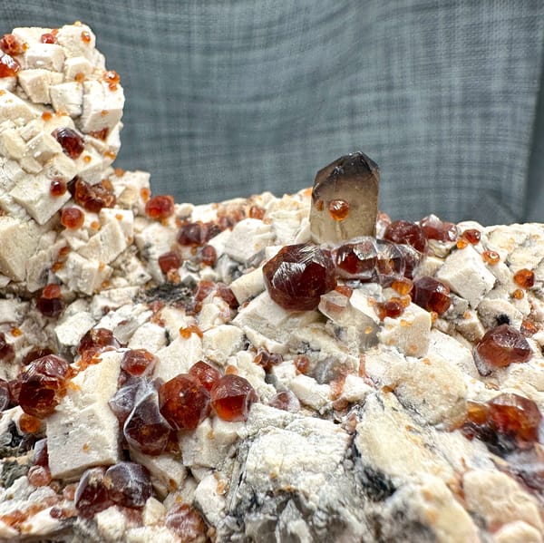 Feldspar plate peppered with wine-red garnets from Yunxiao, Fujian, China, top view
