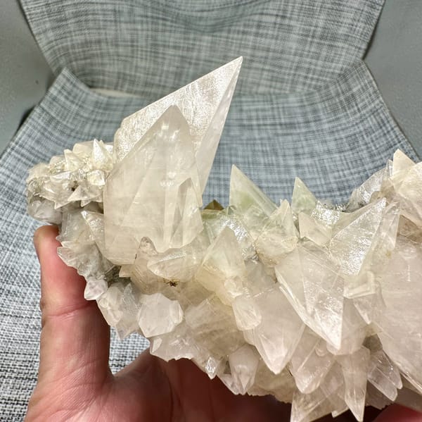 Arc of sharp cream calcite spikes with tall blade from Fujian, China, close-up of the crystal faces
