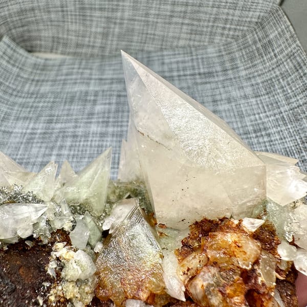 Arc of sharp cream calcite spikes with tall blade from Fujian, China, reverse side