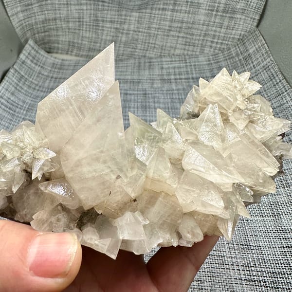 Arc of sharp cream calcite spikes with tall blade from Fujian, China, top view
