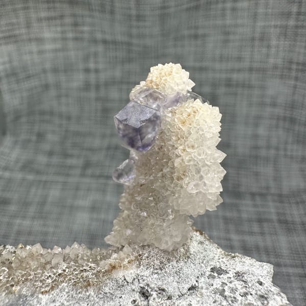 Blue-green fluorite dodecahedron on white quartz stalk from Fujian, China, second angle