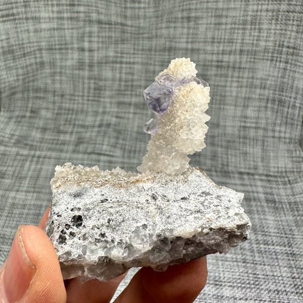 Blue-green fluorite dodecahedron on white quartz stalk from Fujian, China, reverse side