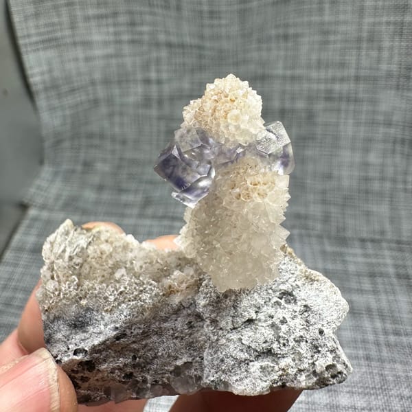 Blue-green fluorite dodecahedron on white quartz stalk from Fujian, China, top view
