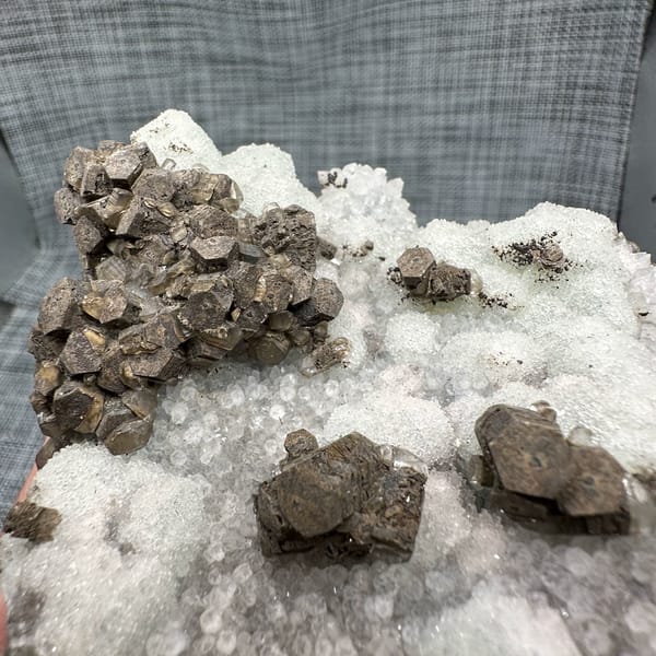 Chocolate-brown calcite clusters on white sugar fluorite plate from Fujian, China, reverse side