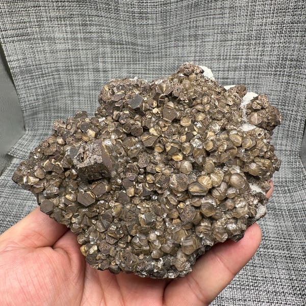 Chocolate-brown calcite clusters on white sugar fluorite plate from Fujian, China, top view
