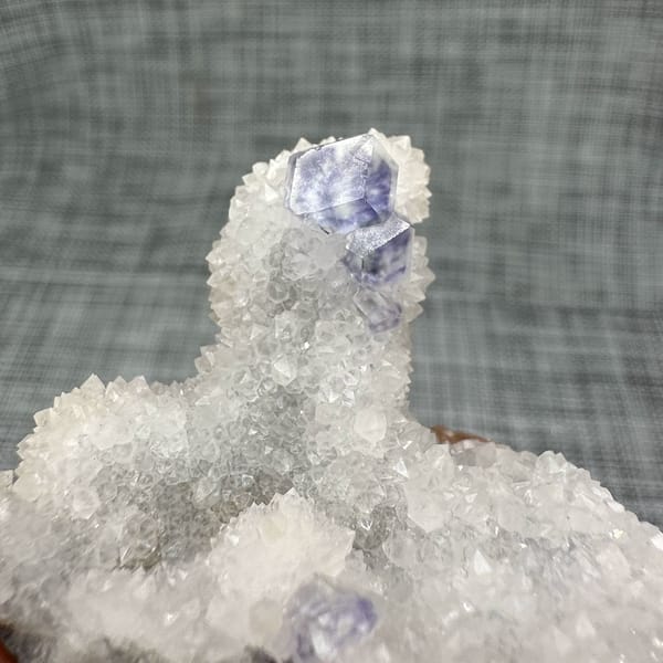 Purple-blue fluorite dodecahedron on white quartz mound from Fujian, China, second angle