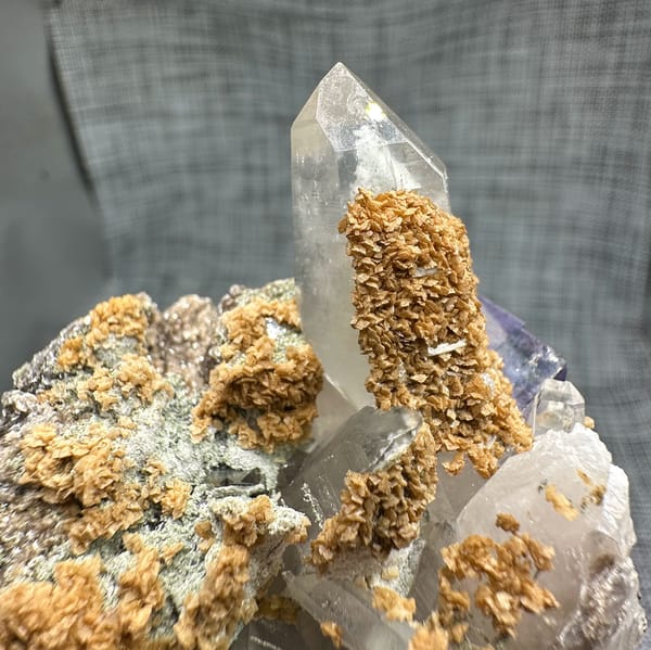 Clear quartz spire with purple fluorite, dolomite and mica from Yaogangxian Mine, Hunan, China, close-up of the crystal faces