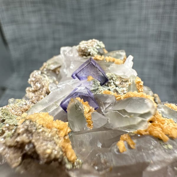 Clear quartz spire with purple fluorite, dolomite and mica from Yaogangxian Mine, Hunan, China, top view