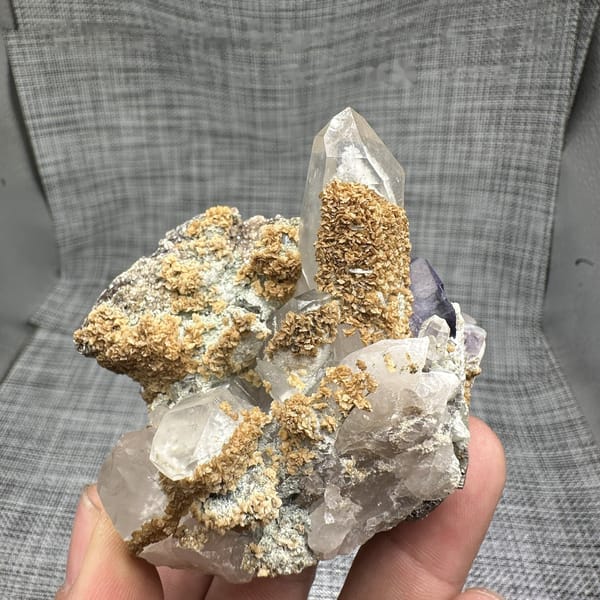 Clear quartz spire with purple fluorite, dolomite and mica from Yaogangxian Mine, Hunan, China, detail of the matrix contact