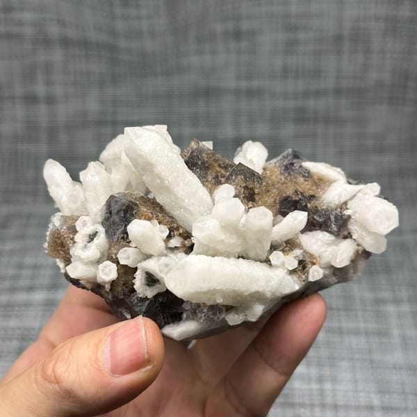 White candle quartz prisms with purple fluorite octahedron from Inner Mongolia, China, reverse side