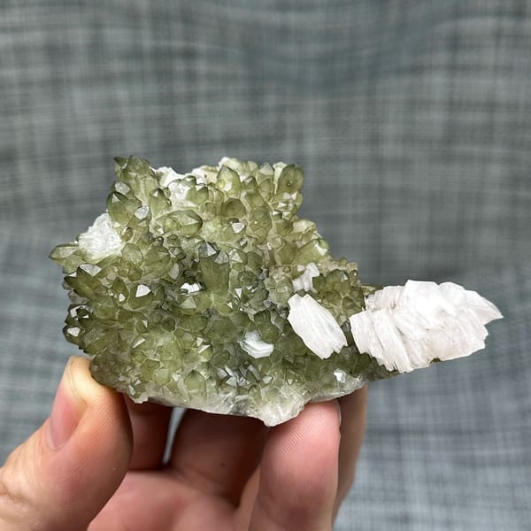 Green chlorite-coated quartz with white hexagonal calcite from Fujian, China, close-up of the crystal faces