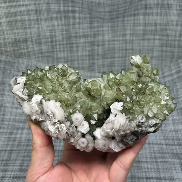Plate of green chlorite quartz with white hexagonal calcite from Fujian, China, close-up of the crystal faces
