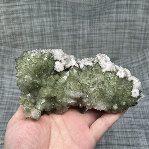 Plate of green chlorite quartz with white hexagonal calcite from Fujian, China, detail of the matrix contact