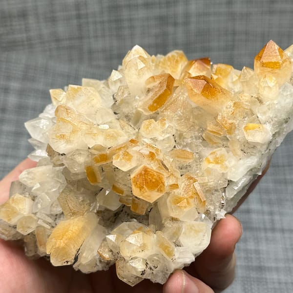Mango-yellow quartz crystals with white hexagonal calcite from Fujian, China, top view