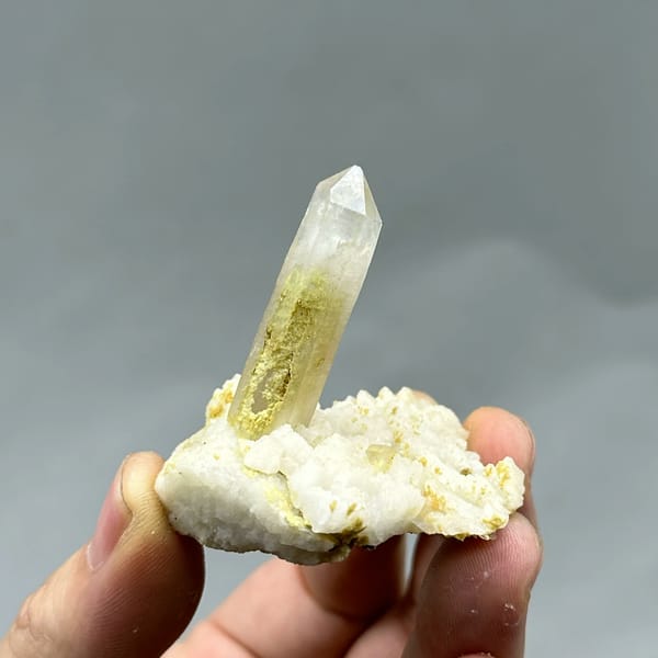 Gradient quartz point standing on white feldspar from Yunxiao, Fujian, China, reverse side