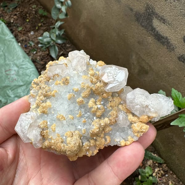 Pale pink calcite with tan dolomite crusts from Jiangxi, China, reverse side