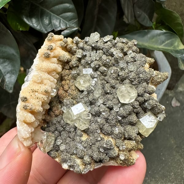 Clear calcite rhombs on pyrite-dusted dolomite from Hubei, China, close-up of the crystal faces