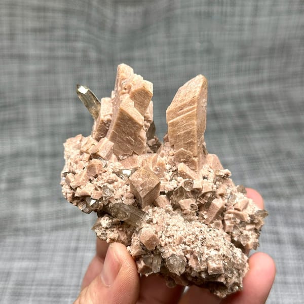 Salmon-pink prismatic feldspar crystals with smoky quartz from Yunxiao, Fujian, China