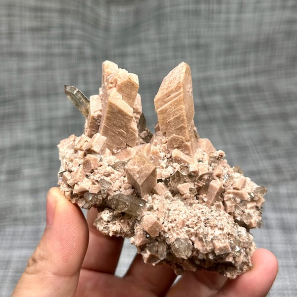 Salmon-pink prismatic feldspar crystals with smoky quartz from Yunxiao, Fujian, China, top view