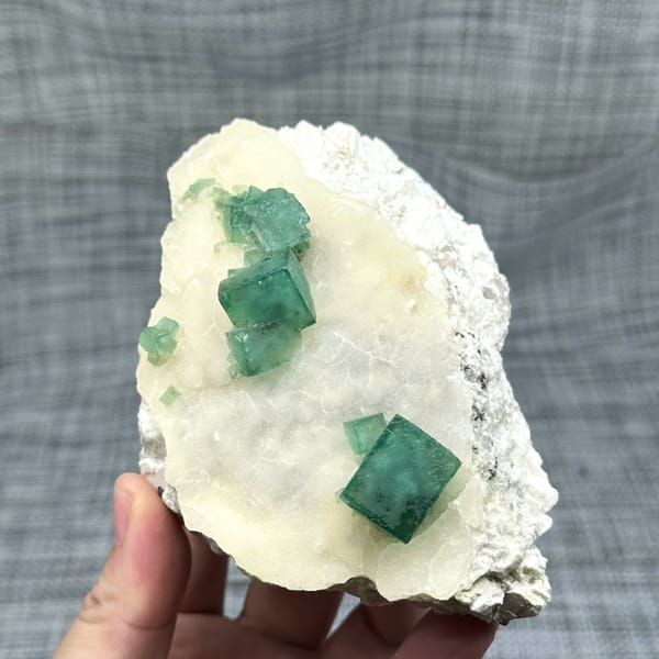 Emerald-green daylight fluorite cubes on cream quartz plate from Madagascar, second angle