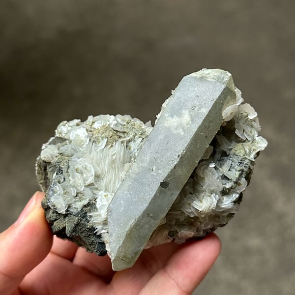 Grey double-terminated quartz on coin-shaped calcite from Inner Mongolia, China, top view