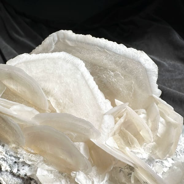 Large translucent platy calcite crystals stacked like petals from Hunan, China, close-up of the crystal faces