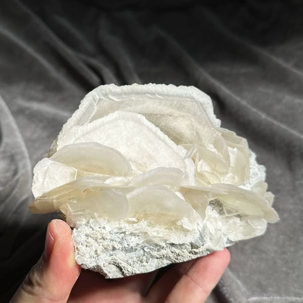 Large translucent platy calcite crystals stacked like petals from Hunan, China, reverse side
