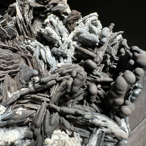 Black pyrolusite blades frosted with white aragonite from Morocco, top view
